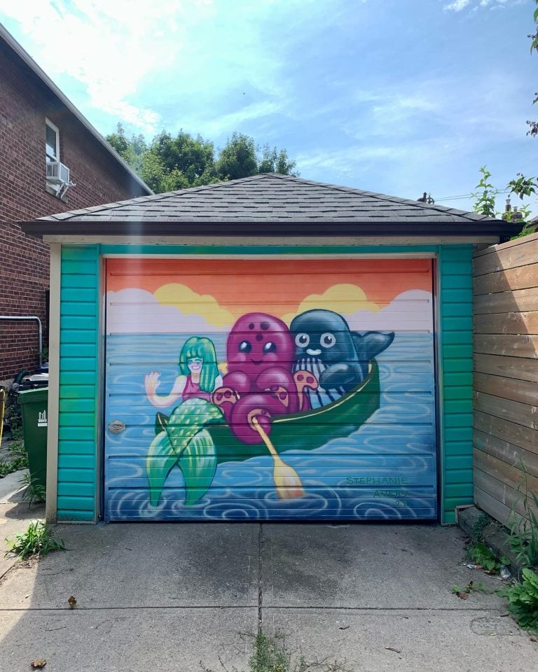 A colourful whale, octopus and mermaid canoeing into the sunset.