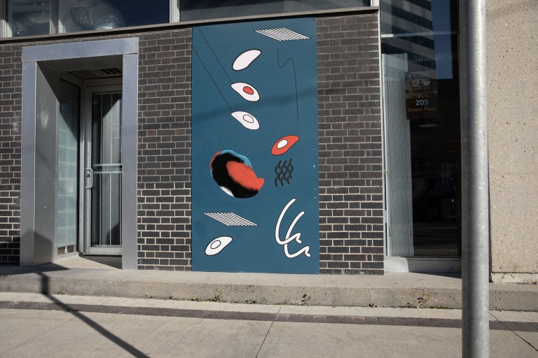 On a narrow, dark blue panel, many wavy lines and shapes are depicted. Two shapes that resemble ceiling grates are seen at the top and bottom of the image. Shapes range from black, white and red.