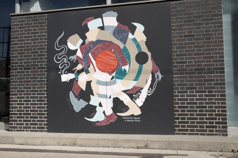 On a black panel, rotating images of a figure is seen holding a cup of coffee. Thick, white lines of steam emerge from the cup. There are three images of the figure that rotate, one wearing a burgendy jacket, and another wears grey, and the other green. They are rotated in a way that forms a target symbol in the centre.