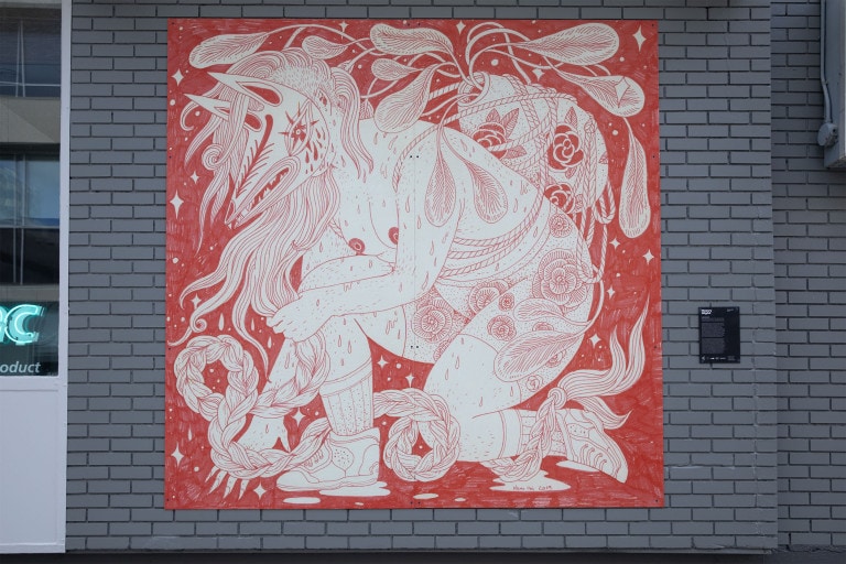 On a red background, a figure with a foxhead crouches on one knee, holding their long hair that is braided. The figure wears skeakers with long sochs and shorts with flowers on them. A potted plant is tied to their back with rope, and sweat drips down their body.