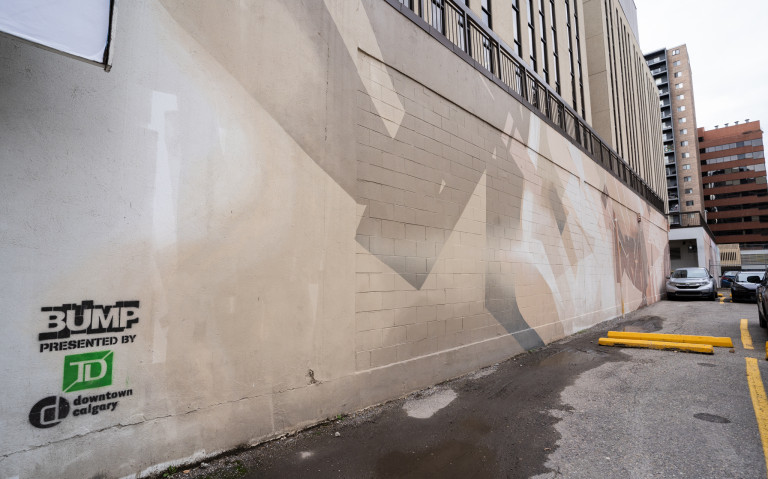 Abstract linework with sponsored stamp on wall.