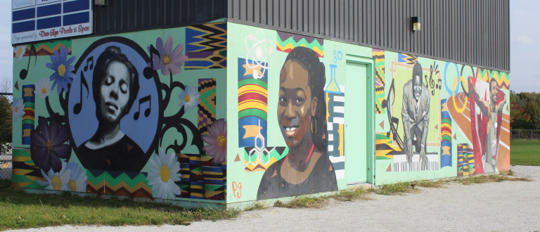 Images shows a mural with 4 famous Black Canadians, including Portia White, Oscar Peterson, Dr. Eugenia Duodu and Andre De Grasse.