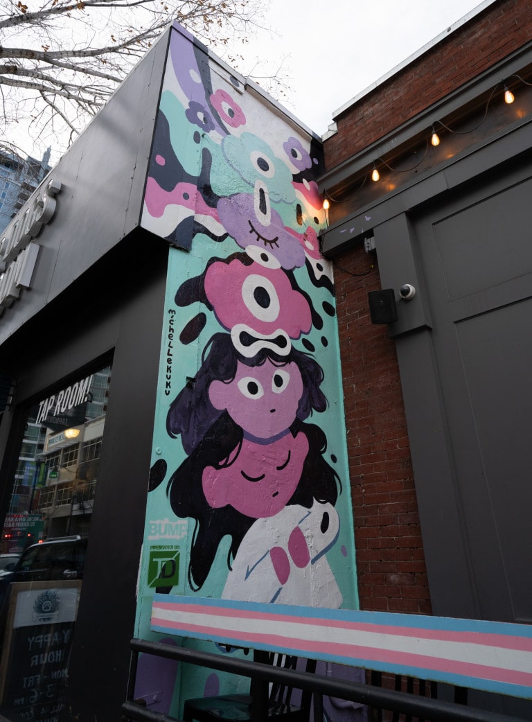 From bottom to top. Girl sleeping with open eyed head on top, simplified head on top of another. Blobs at top, pinks, turquoise, purples and blacks