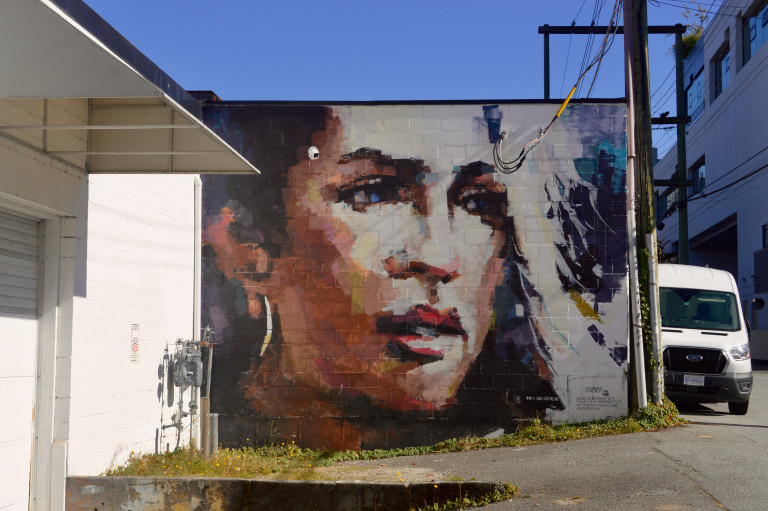 An impressionist portrait of a woman with dark hair looking to the side