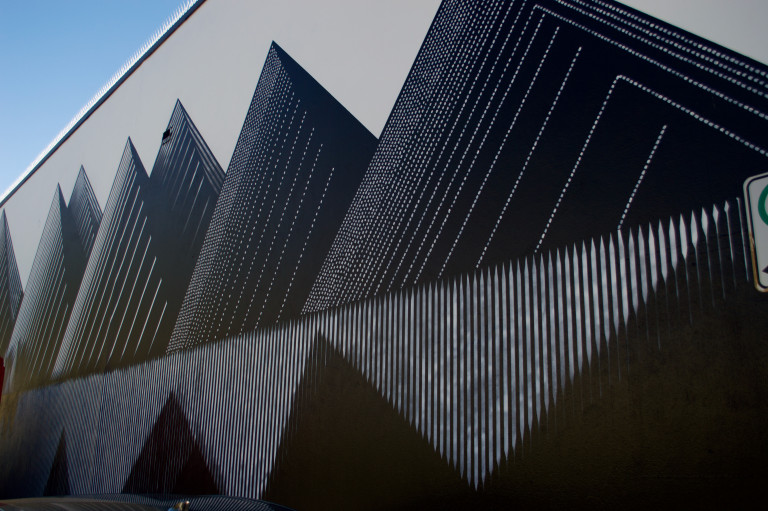 A geometric minimalist rendering of a mountain landscape in black and white