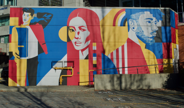 Large geometric colourful shapes framing portraits of students