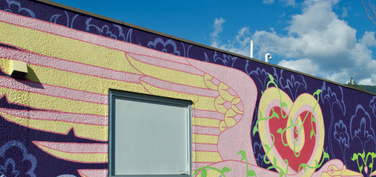 S wide shot of a heron's wing against a purple background