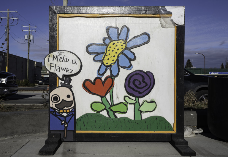 Character with a monocle, top hat, cane, and blue suit on the left corner side with text bubble: "i MehD u FlawRZ."  Red, yellow and purple flower in center.