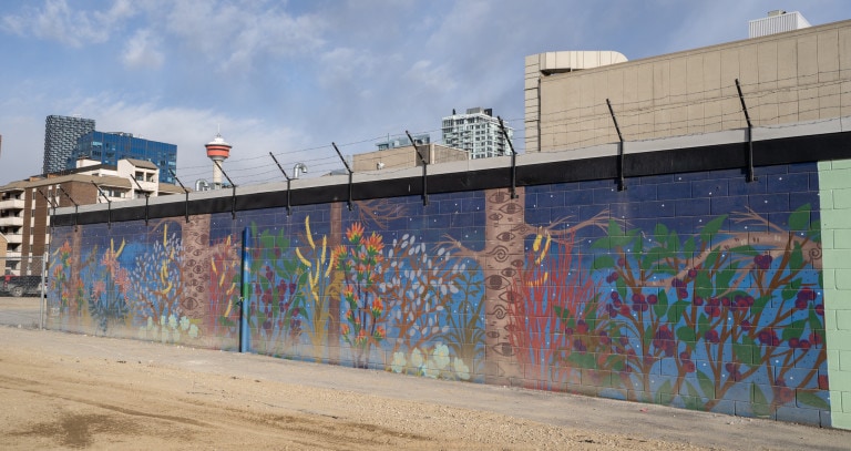 Tree with eyes on them and plants spreading out with flowers.