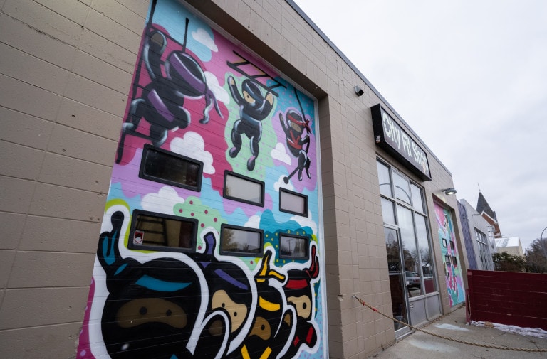 Ninjas climbing ladders in air and cheering. Colourful abstract background.