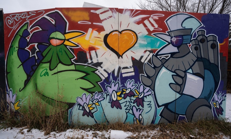 Left to right. Godzilla-like chicken with small little chickens in middle. Orange heart floating on top of little chickens. Robotic chicken on right side.