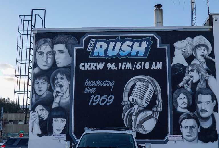 A collection of portraits of famous musicians flanking their station information.