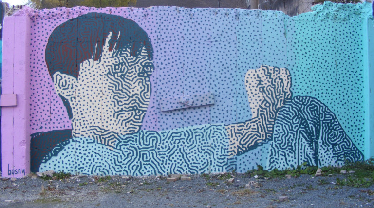 A portrait of a young child's face, comprised of squiggles and swirls.